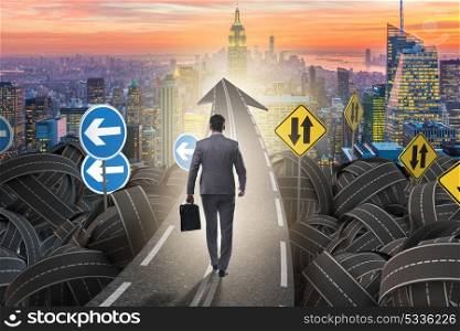 Businessman in uncertainty concept on road intersection crossroads. Businessman in uncertainty concept on road intersection crossroa