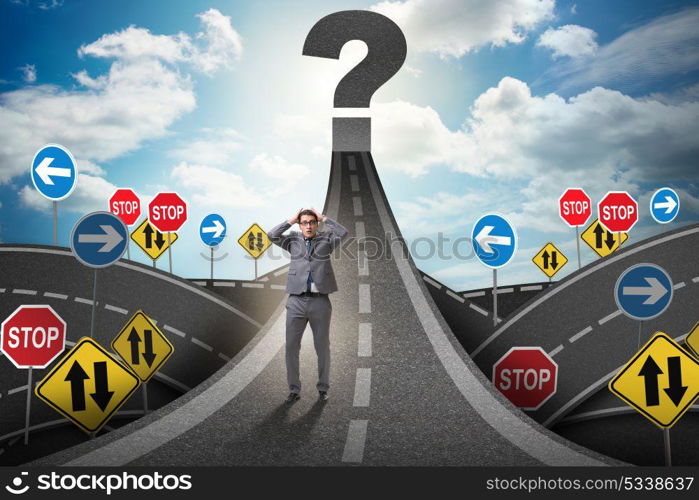 Businessman in uncertainty concept on road intersection crossroads. Businessman in uncertainty concept on road intersection crossroa