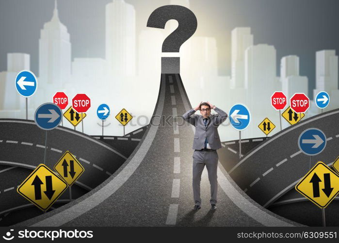 Businessman in uncertainty concept on road intersection crossroads. Businessman in uncertainty concept on road intersection crossroa