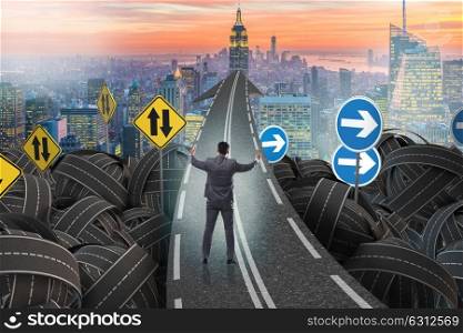Businessman in uncertainty concept on road intersection crossroads. Businessman in uncertainty concept on road intersection crossroa