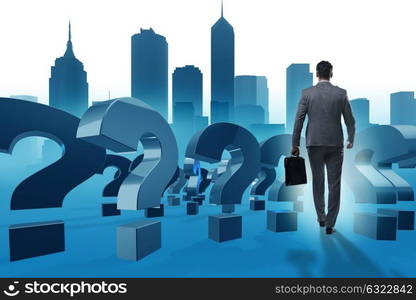 Businessman in uncertainty concept with question marks