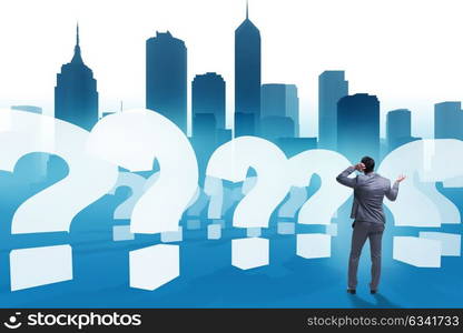 Businessman in uncertainty concept with question marks