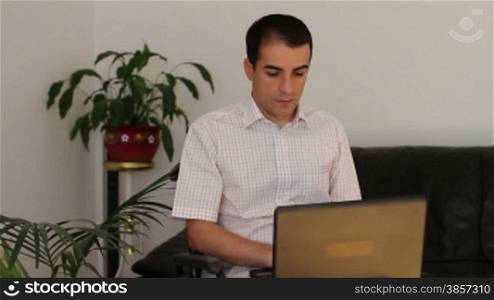 Businessman in wheelchair working on laptop computer