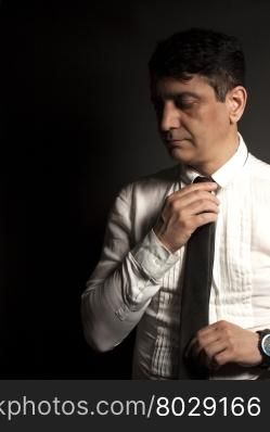 Businessman in white shirt on black background