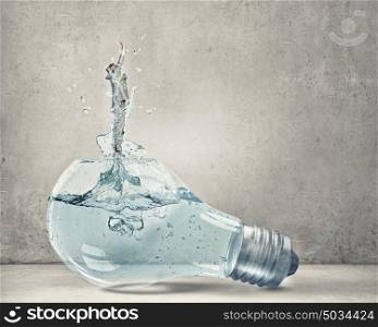 Businessman inside bulb. Glass light bulb filled with clear water and businessman inside