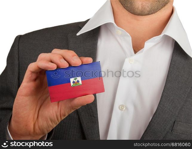 Businessman is holding a business card, flag of Haiti