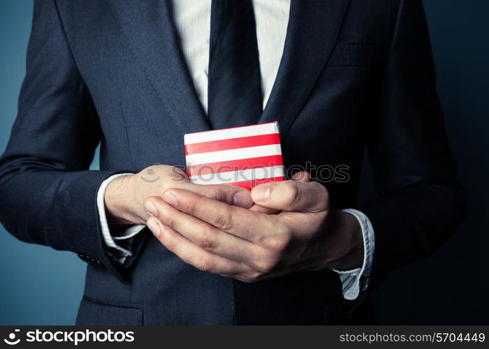 Businessman is holding a small gift