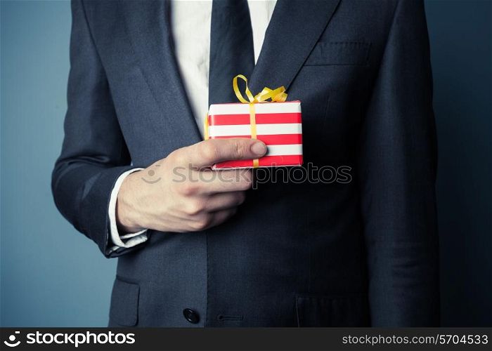 Businessman is holding a small gift