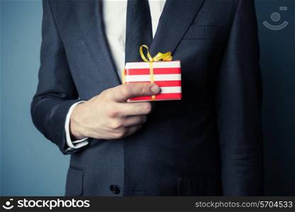 Businessman is holding a small gift