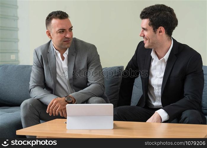 Businessman is in meeting discussion with another businessman partner in modern workplace office. People corporate business team concept.
