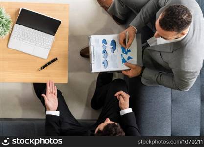 Businessman is in meeting discussion with another businessman partner in modern workplace office. People corporate business team concept.