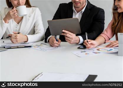 Businessman is in meeting discussion with colleague businesswomen in modern workplace office. People corporate business team concept.