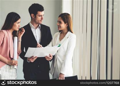 Businessman is in meeting discussion with colleague businesswomen in modern workplace office. People corporate business team concept.. Businessman and businesswomen working in office.