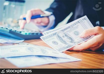 Businessman is Savings money and calculating