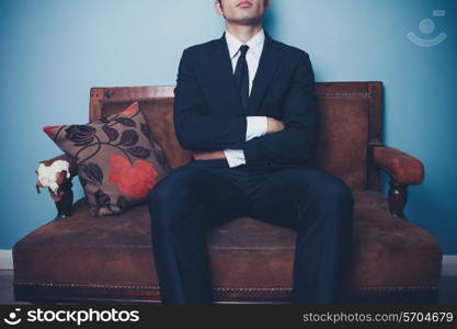 Businessman is sitting on a sofa