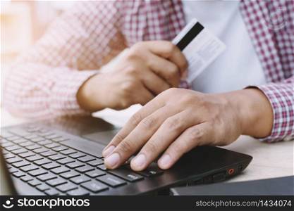 Businessman is using credit cards to buy products online