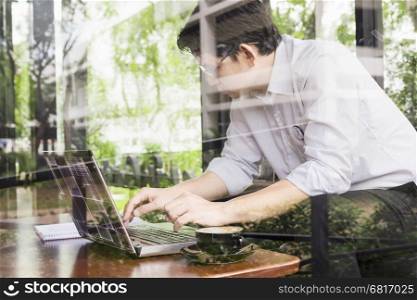 Businessman is working with his computer in coffee shop