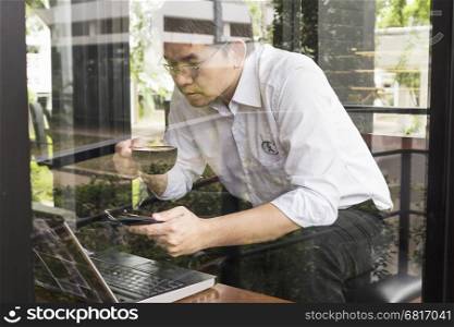 Businessman is working with his computer in coffee shop
