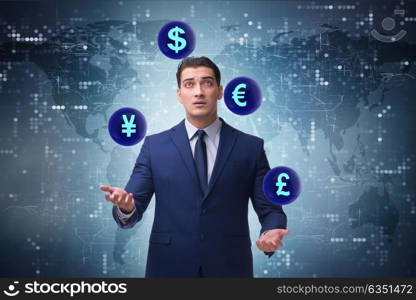 Businessman juggling between various currencies