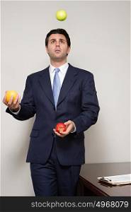 Businessman juggling fruit
