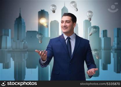 Businessman juggling lightbulbs in new idea concept