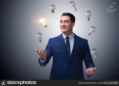 Businessman juggling lightbulbs in new idea concept