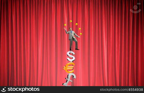 Businessman juggling with balls. Young businessman balancing on currency signs and juggling with balls