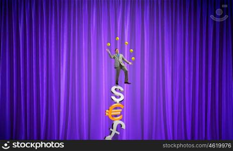 Businessman juggling with balls. Young businessman balancing on currency signs and juggling with balls