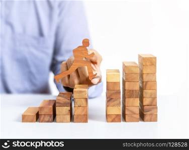 businessman jump across the gap on wooden block