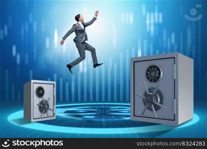 Businessman jumping from safes in business concept