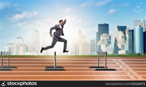 Businessman jumping over barriers in business concept