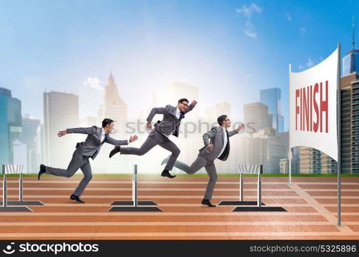 Businessman jumping over barriers in business concept