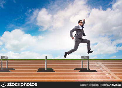 Businessman jumping over barriers in business concept