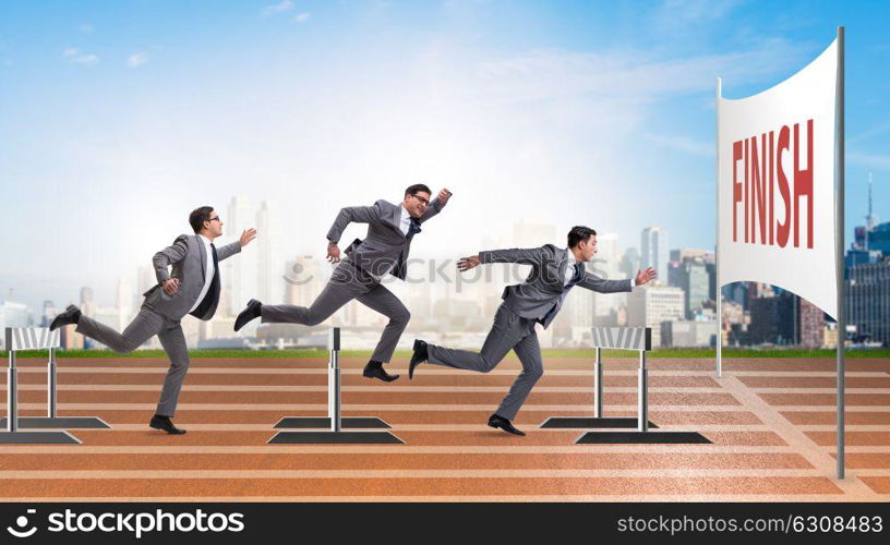 Businessman jumping over barriers in business concept