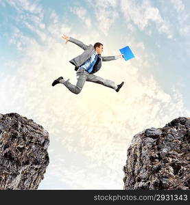 Businessman jumping over gap