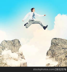 Businessman jumping over gap