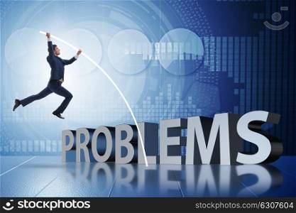 Businessman jumping over problems in business concept