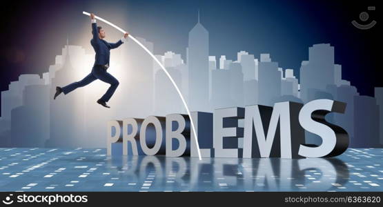 Businessman jumping over problems in business concept