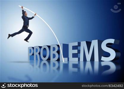 Businessman jumping over problems in business concept. The businessman jumping over problems in business concept