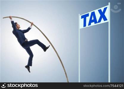 Businessman jumping over tax in tax evasion avoidance concept. The businessman jumping over tax in tax evasion avoidance concep
