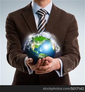 Businessman keeps the world in his hands