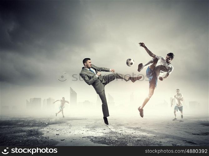 Businessman kicking ball. Young businessman in suit playing football outdoors