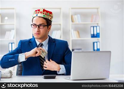 Businessman king with money in the office