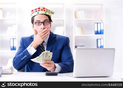 Businessman king with money in the office
