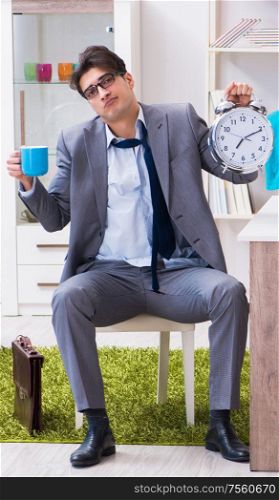 Businessman late for office due to oversleeping after overnight working. The businessman late for office due to oversleeping after overni