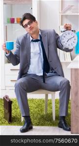 Businessman late for office due to oversleeping after overnight working. The businessman late for office due to oversleeping after overni