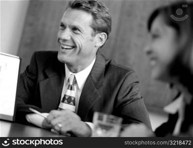 Businessman Laughing At Board Meeting