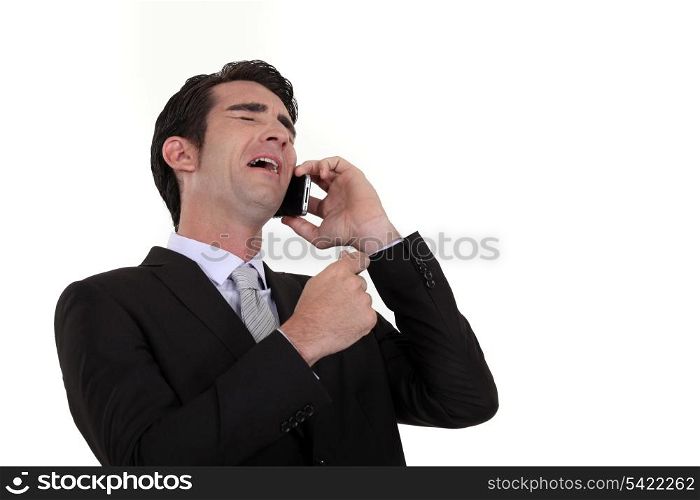Businessman laughing during telephone call