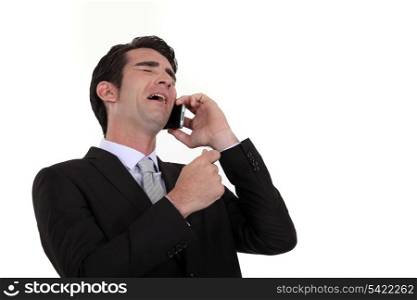 Businessman laughing during telephone call