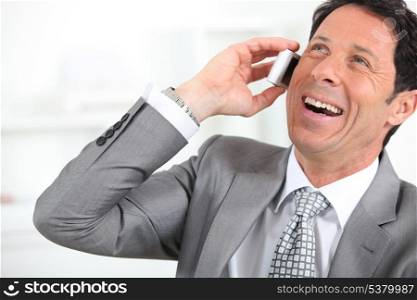 businessman laughing on the phone